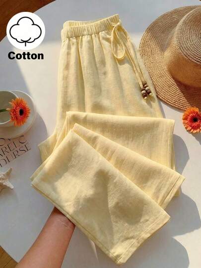 SHEIN Glamour 奶油米白色棉质梭织阔腿裤，高腰弹力设计，侧边抽绳可调节，饰有木珠流苏；宽松垂坠，透气舒适，是夏季通勤、旅行和海岛度假的理想之选。可搭配背心/抹胸和凉鞋。关键词：女士沙滩裤、女士沙滩装、女士度假装、外出装、阔腿裤、棉质裤、夏季阔腿裤、抽绳棉质裤、奶油黄裤