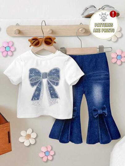 SHEIN طقم بنات رضع كاجوال أنيق وجميل مكون من تي شيرت بأكمام قصيرة مزين بطبعة فيونكة وبنطلون واسع مزين بطبعة فيونكة، صيفي