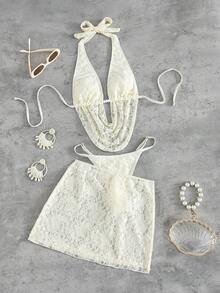 Swim SXY 这款女士欧美风性感大胆前卫的日常法式度假百搭泳衣套装，采用米白色蕾丝面料，饰以串珠配饰，系带露背吊带深V设计，搭配后背褶皱泳裤和外层蕾丝裙，三件套设计，适合春假、秋季返校季、啤酒节、音乐节、春季促销、海滩度假、春季派对、情人节等场合。 - 杏色 - 查看 4