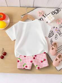 Souflis Souflis Bộ 2 món cho bé gái, gồm áo thun ngắn tay in hình quả anh đào và nơ xinh xắn, cùng quần short kẻ caro hồng trắng, thích hợp cho các hoạt động ngoài trời mùa hè. - Nhiều màu - Xem 2