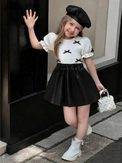 Elladie kids Bộ đồ thời trang mới Xuân/Hè 2026 cho bé gái, chất liệu mềm mại, dễ thương, gồm áo thun cổ tròn tay phồng họa tiết bướm và chân váy da PU, thích hợp cho du lịch, đi làm và đi học.