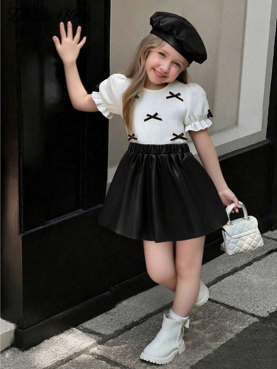 Elladie kids 2026春夏新款时尚柔软舒适面料度假旅行必备少女蝴蝶结装饰圆领泡泡袖T恤+PU裙套装，适合日常、通勤和上学穿着 - 黑與白 - 查看 1