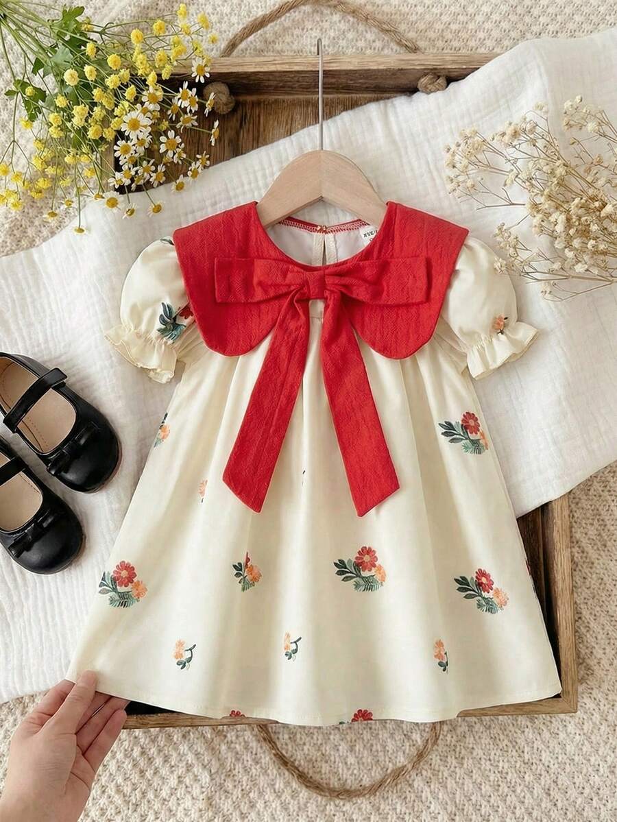 SHEIN 女童甜美碎花连衣裙，带蝴蝶结和荷叶边袖子，适合幼儿的公主裙，可爱日常穿着，白色底色搭配彩色印花 - 杏色 - 查看 1