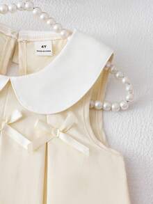 SHEIN Elladie kids Bộ đồ bé gái gồm áo vest xếp ly màu tím dễ thương có nơ trang trí, kết hợp với quần ống rộng thời trang, phù hợp cho mặc hàng ngày và đi làm, phong cách tối giản. - Màu be - Xem 7