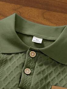 SHEIN Streecool Kids 一件男童米色 Polo 衫，领口和袖口饰有黑色滚边，增添细节感，表面菱形纹理提升质感，左胸创意“皮革贴片”设计，适合商务休闲、日常通勤、半正式社交活动和学校穿着。 - 軍綠色 - 查看 3