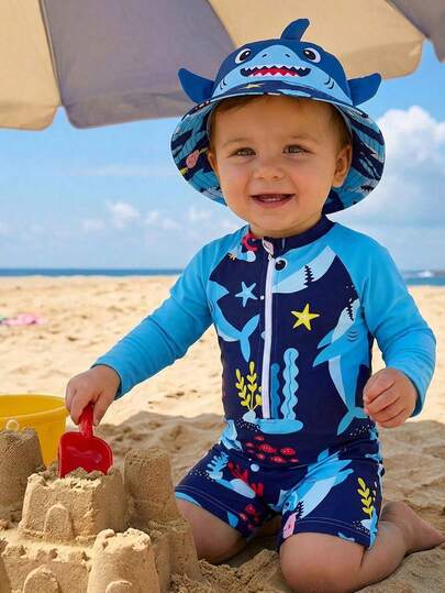 Traje de baño con cremallera para bebés, con estampado de tiburón y criaturas marinas. Elemento de moda esencial para vacaciones de verano en la playa. Diseño de manga larga, contraste de color azul, lindo estampado de dibujos animados de tiburón y criaturas marinas. Diseño alegre. Apropiado para que bebés niños usen durante los juegos y vacaciones en la playa.
