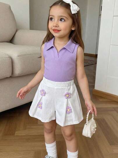 Elladie kids Bộ đồ đi nghỉ mát dễ thương cho bé gái, gồm áo polo cổ chữ V có cổ, phối cùng quần short cạp cao xếp ly, được làm thủ công bằng len họa tiết hoa.