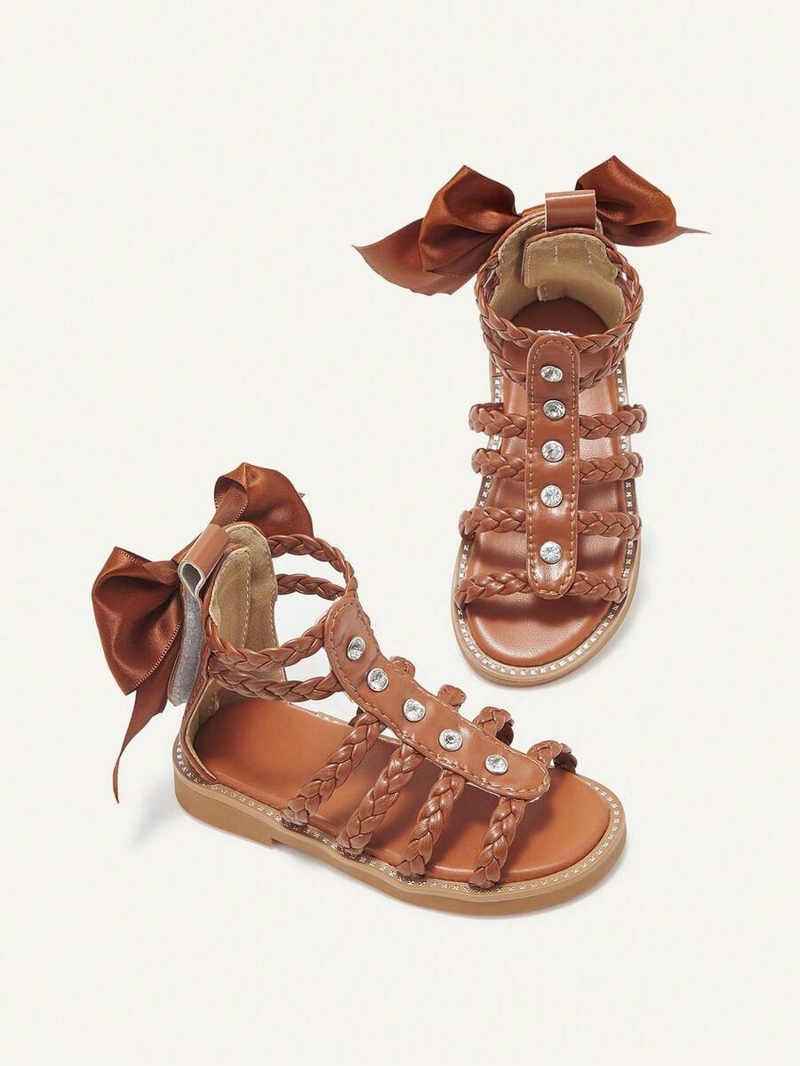 Cozy Pixies Một đôi sandal đế bằng kiểu La Mã dễ thương, đa năng, mang phong cách bohemian, lý tưởng cho kỳ nghỉ hè, thích hợp cho bé gái, kiểu dáng giản dị, thoải mái, có nơ và đan, thích hợp đi biển. - màu nâu - Xem 1