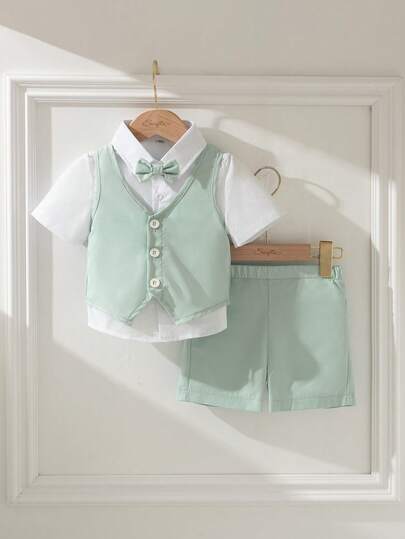 Souflis Souflis 3pcs Baby's First Mother's Day Set: Sleeveless Vest, Shorts, And Bow Tie. The Vest Is In Light Gray With A Decorative Button Detail, Paired With A Small Multi-Color Bow Tie. The Shorts Are In Light Green To Match The Vest. Suitable For Children's Occasions Such As Small Weddings, Children's Concerts, Etc.
