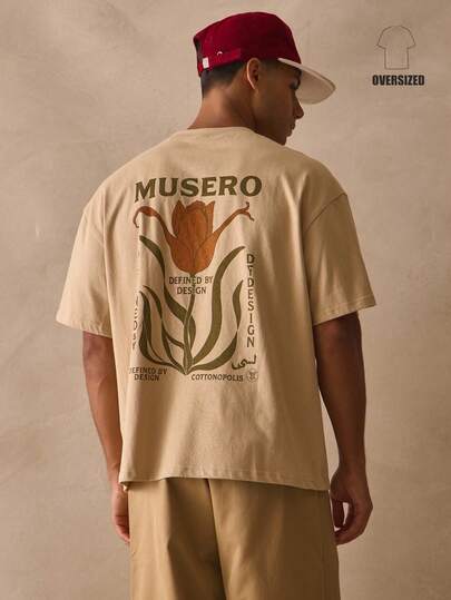 Musero Camiseta de manga corta con cuello redondo, hombros caídos y estampado floral grande en la espalda, esencial para primavera y verano