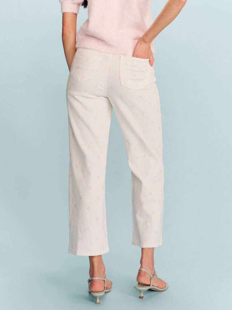 Jeans in denim color sabbia con ricamo floreale in vita alta