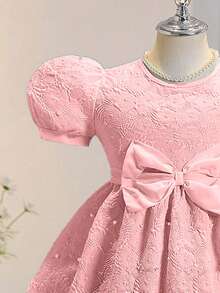 Đầm hè thanh lịch, sang trọng, cổ tròn, tay phồng, eo cao, màu trơn, chất liệu jacquard, nơ và đính ngọc trai. - Hồng - Xem 6