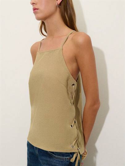 Nöista Halter Top In Green Color With Side Openings And Tie In Criss Cross To Close It. Summer Outfit, Beach, Casual Look, Easter, Pring, Holiday, Vacay, Vactions Look.