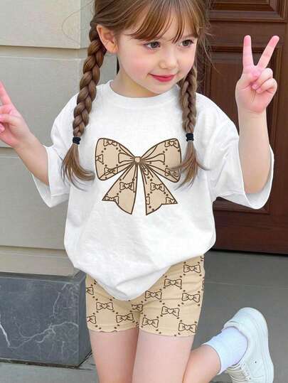 SHEIN 2pcs Baby Girl Cute Cartoon Bow Print Short Sleeve T-Shirt And Elastic Waist Shorts Set, Summer