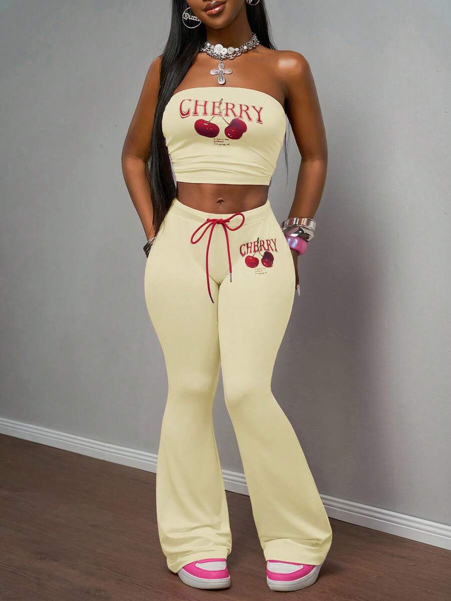Slaydiva 2025 Spring/Summer New Bohemian Music Festival Countryside Style Easter Casual Daily Beach Vacation Party Street Fashion Sexy Sweet Cute Y2K Pink Elastic Knit Fabric Red Cherry Fruit English Letter Graphic Retro American Print Sleeveless Cold-Shoulder Tight Bandeau Crop Top Paired With Pink Elastic Waist Red Rope Tie Cherry Print Tight Flare Pants Women 2-Piece Set - Light Yellow - View 1
