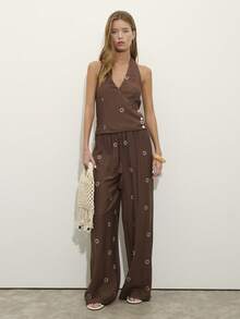Nöista Two Pieces Set With A Halter V-Neck Top And Matching Wide-Leg Pants In Textured Brown Fabric With Sun Embroidery. . Perfect For Travel, Weekends, And Summer Days, Vacation Outfit, Boho, Festival, Spring, Holiday Look. - Brown - View 1
