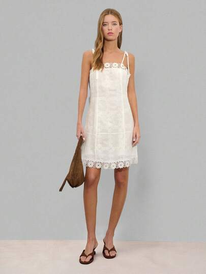 Nöista White Mini Dress Floral Embroidery With A Fitted Bodice And Gently Flared Skirt. Features A Straight Neckline, Adjustable Tie Shoulder Straps, And Scalloped Lace Hem. Ideal For Summer Parties, Bridal Events, Vacations, Formal Events, Spring, Music Festival, Music Festival, Beach Day.