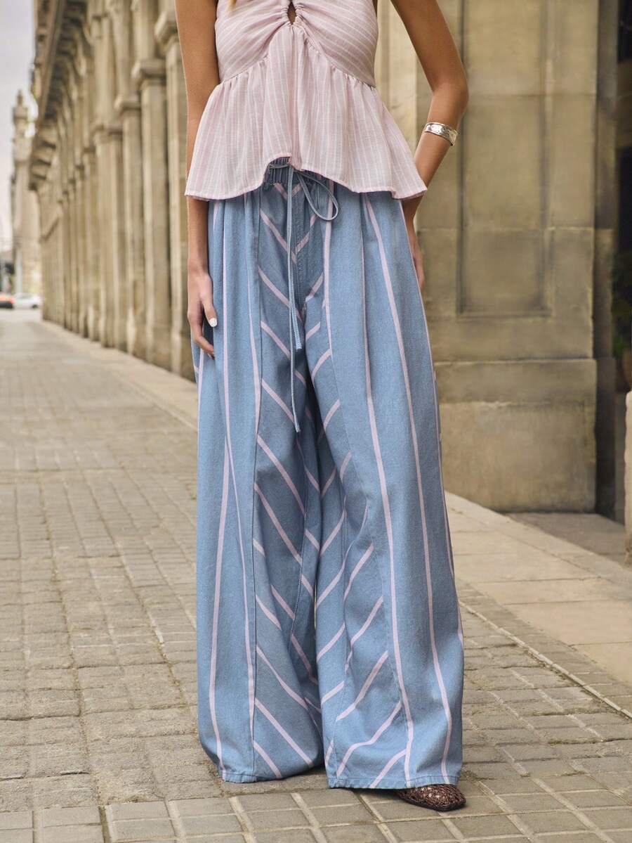 Nöista Quần dài màu xanh dương và tím in sọc rộng, chất liệu denim, có dây buộc eo và chun ở cạp quần, họa tiết sọc phối hợp. Thích hợp cho lễ hội âm nhạc, mùa hè, mùa xuân, đi biển, trang phục thường ngày cho nữ. - Màu xanh lam - Xem 1