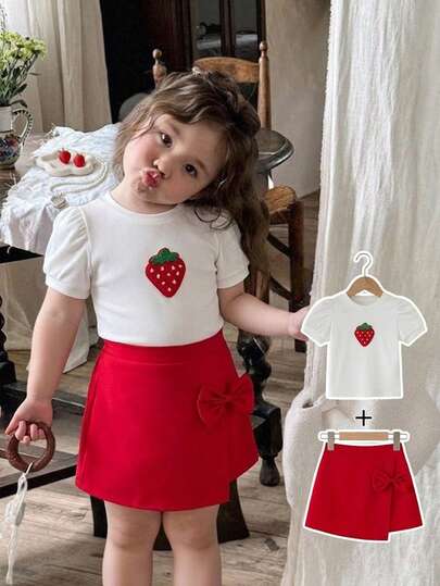 2pcs/Set Baby Girls' Korean Style Elegant Sweet Cute Strawberry Striped Round Neck Puff Sleeve Casual T-Shirt + Versatile Bow Irregular Hem Mini Skirt Outfit, Suitable For Valentine's Day, Holiday, Vacation, Daily Wear, Spring/Summer/Autumn