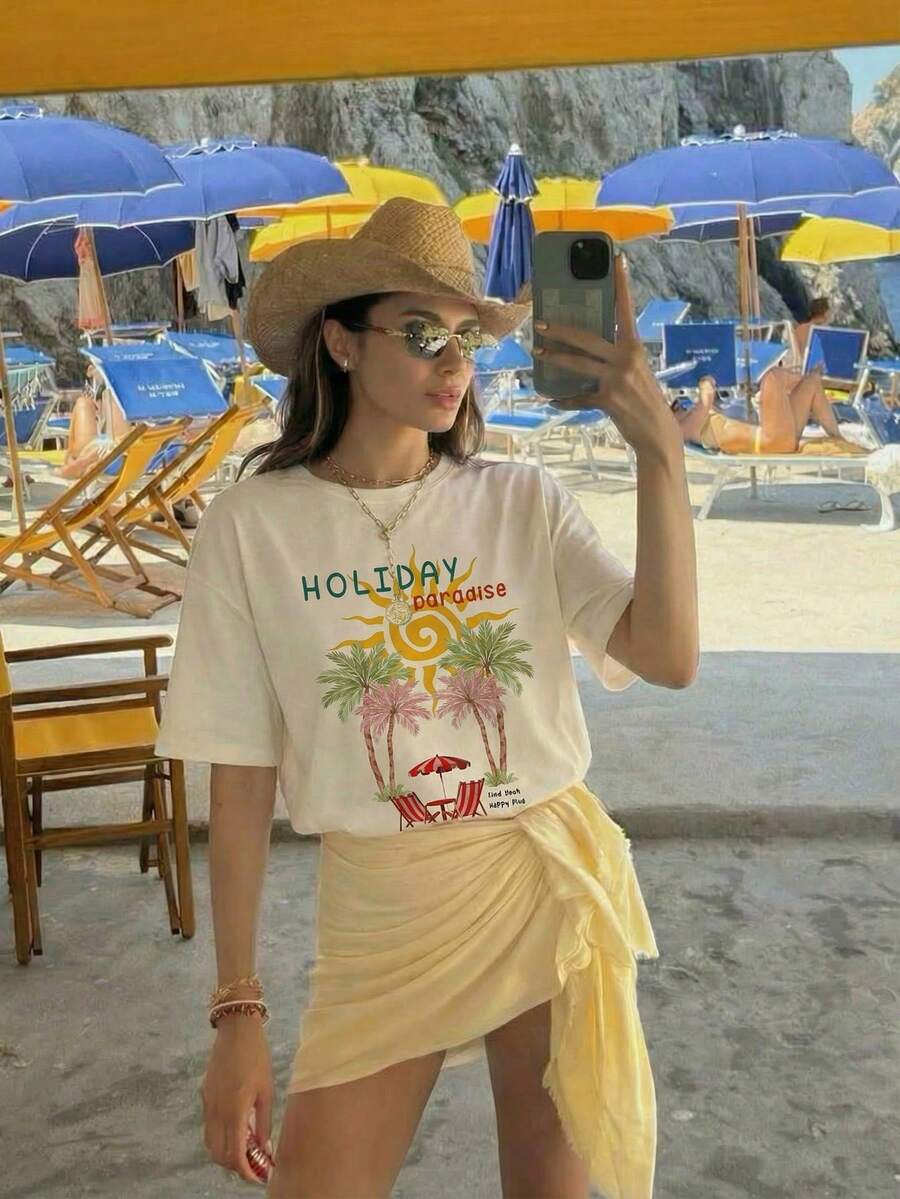 Aloruh 宽松T恤，饰有休闲棕榈树和法国里维埃拉图案，圆领短袖，宽松版型，适合夏季度假、海滩穿着。黄色夏季上衣，Y2K风格夏季服装，假日装扮，夏季女装，夏季度假装扮，夏季女装，夏季度假装扮，假日海滩装，女士度假服装。 - 杏色 - 查看 1