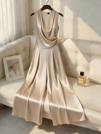 Franclia Elegancki, romantyczny, modny, damski kombinezon do pracy, seksowny i wyjątkowy, odpowiedni na dojazdy do pracy, służbowe, święta, romantyczne randki i wesela, urodziny i Walentynki. Bez rękawów, luźne, szerokie spodnie w kolorze morelowym, marszczenia w talii, zdobione guzikami w kolorze szampańskim. Formalny kombinezon satynowy, elegancki kombinezon z efektem jedwabiu. Damski kombinezon.