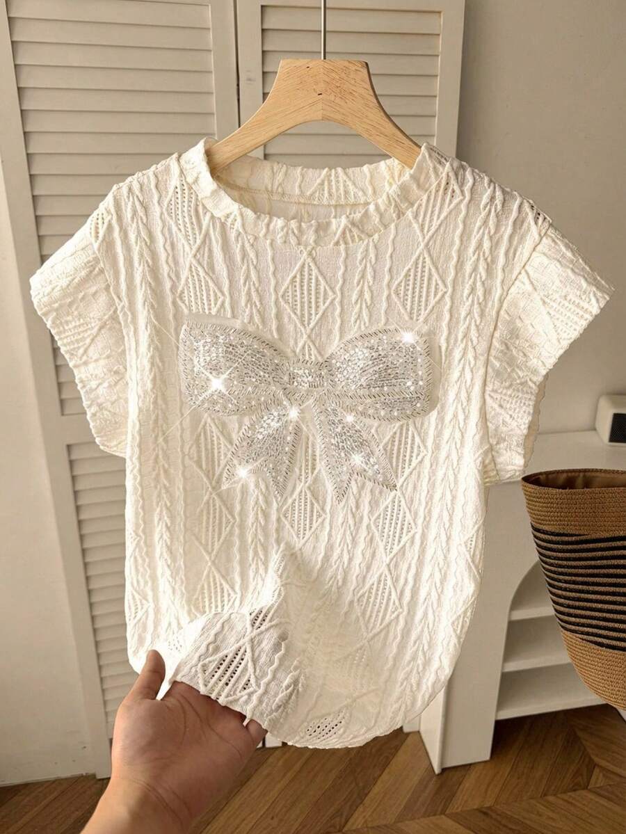 少女白色春夏休闲优雅宽松落肩圆领纹理刺绣细节串珠超大蝴蝶结装饰T恤，杏色 - 白色 - 查看 1