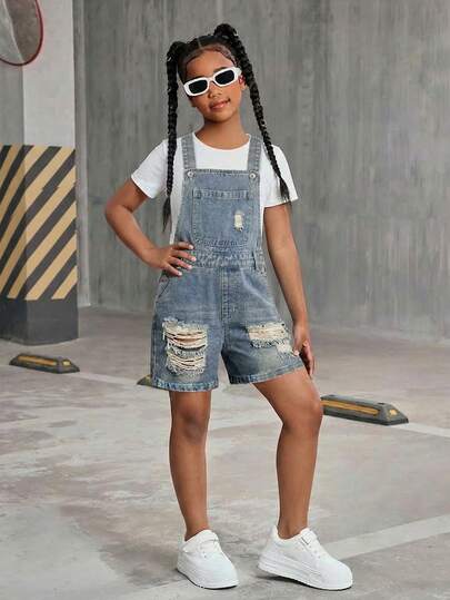 Vintage Denim Jumpsuit Shorts For Teenage Girls, Casual Street Style Recommended. Distressed Denim Blue With Faded Wash, Natural Ripped Thighs For Relaxed Look. Classic Adjustable Suspenders And Buttons, Front Pockets And Side Pockets. Retro And Practical For Daily Wear With White T-Shirt And Canvas Shoes, Back To School Look. Pair With Floral Camisole And Straw Bag For Casual Yet Chic Date Outfit. Denim Short Set Kids Girls Denim Overalls Shorts Girls Overall Shorts