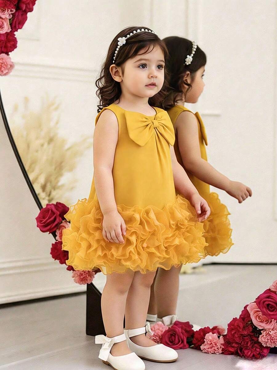 Elladie kids Vestido elegante sin mangas para niñas bebé con decoración de lazo y volantes de malla, moda minimalista para primavera y verano - Amarillo - Ver 1