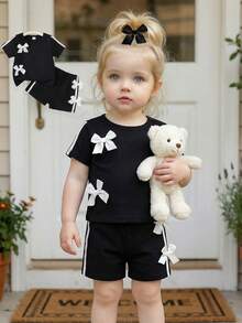 SHEIN Baby Girls' Chic 2-Piece Black Outfit Set, Short Sleeve Crew Neck Top With White Bow Accents & Side Stripe Details, Matching Elastic Waist Shorts With Bows, Ultra-Soft Lightweight Breathable Fabric, Sweet Sporty Casual Style For Everyday Wear, Playdates & Outdoor Activitie - Black - View 4