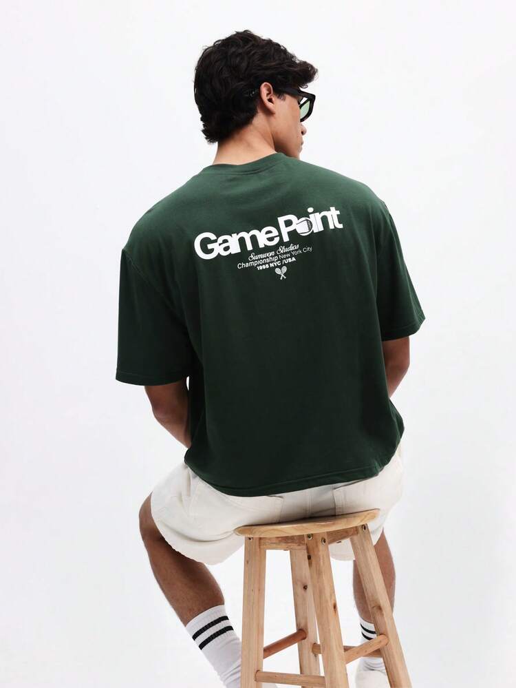 Camiseta de manga corta de cuello redondo con ajuste boxy casual para hombres, con estampado en la espalda de punto de juego, estilo de calle de verano de algodón