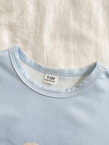 Bộ 2 món cho bé trai gồm áo thun cổ tròn in hình gấu ngồi dễ thương và quần in hình gấu kẻ caro xanh trắng, thoải mái và chống cháy. - Màu xanh lam - Xem 4