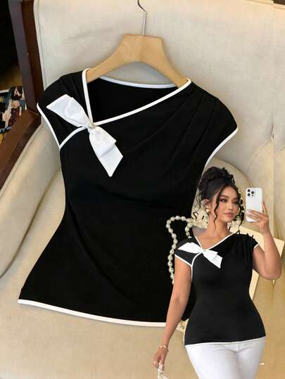 Elenzga Áo kiểu nữ cỡ lớn thanh lịch không tay phối màu tương phản, nơ bất đối xứng và khuy cài trang trí ngọc trai, bộ sưu tập Xuân/Hè 2026.