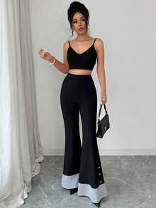 Elenzga 这款女士打底裤采用柔软舒适的牛奶丝面料，全弹力腰带设计，穿着舒适贴身，尽显曼妙身姿。喇叭裤腿、条纹裤脚和金属纽扣点缀，更添优雅纤细气质。适合外出、旅行和聚会等各种场合，是女士衣橱必备单品。 - 黑色 - 查看 8