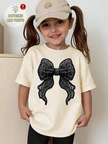 SHEIN Girls' Casual Faux Rhinestone Bow Print Short Sleeve T-Shirt, Creative Butterfly Print Black Bow Short Sleeve Top, Versatile Spring/Summer - Apricot - View 7