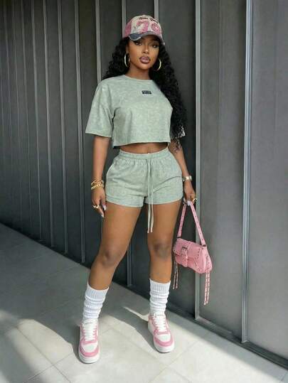 Slaydiva 2026 Spring/Summer New Casual Street Style Green Loose-Fitting Faux Snowflake Crew Neck Label Short-Sleeved T-Shirt + Mini Shorts Women Two Pieces Set.Suitable For Everyday Wear, Casual,Shopping, Travel, Vacation, Beach, Western, Nomadic, Boho, Airport Outfits, Festivals, Concerts,Dates,Sports, Yoga,Party