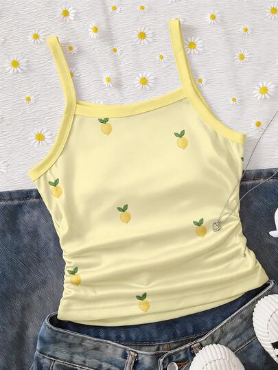 SHEIN Refreshing And Gentle Yellow Camisole. The Shoulder Straps Outline A Neat Line, And The Body Is Decorated With A Small Lemon Embroidery, Like The Dancing Little Light Spots In The Summer, Lively And Playful. The Hem Is Slightly Gathered, Which Not Only Shows The Waistline But Also Has A Sense Of Casual Relaxation, Suitable For Daily Leisure Scenes Such As Home, Shopping, And Afternoon Tea. It Can Also Shine In Summer Outings And Light Social Gatherings, As If Wearing The Breeze And Sweetness Of Early Summer.