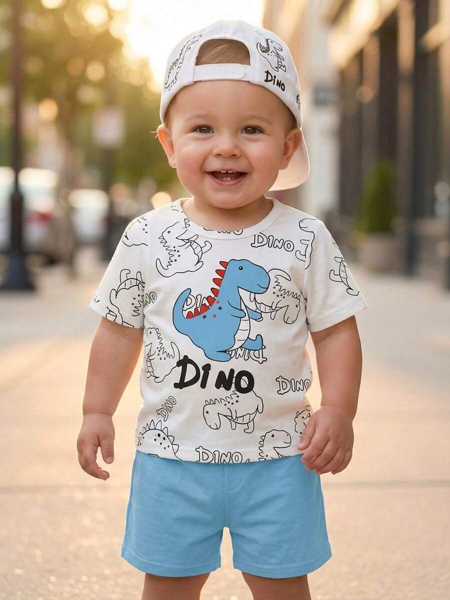 SHEIN Playful Pals Bộ quần áo mùa hè cho bé trai, màu trắng và xanh lá cây, in hình khủng long hoạt hình, gồm áo tay ngắn và quần short, thích hợp cho các buổi đi chơi, dự tiệc, hoạt động hàng ngày và các chuyến đi gia đình. - Màu xanh lam - Xem 1