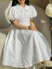 SHEIN Vestido casual y elegante para niñas preadolescentes de primavera/verano con estampado floral de jacquard, decoración de moño, cuello con strass, falda acampanada y mangas abullonadas, color blanco, adecuado para el Día de San Valentín, bodas y fiestas - Blanco - Ver 1