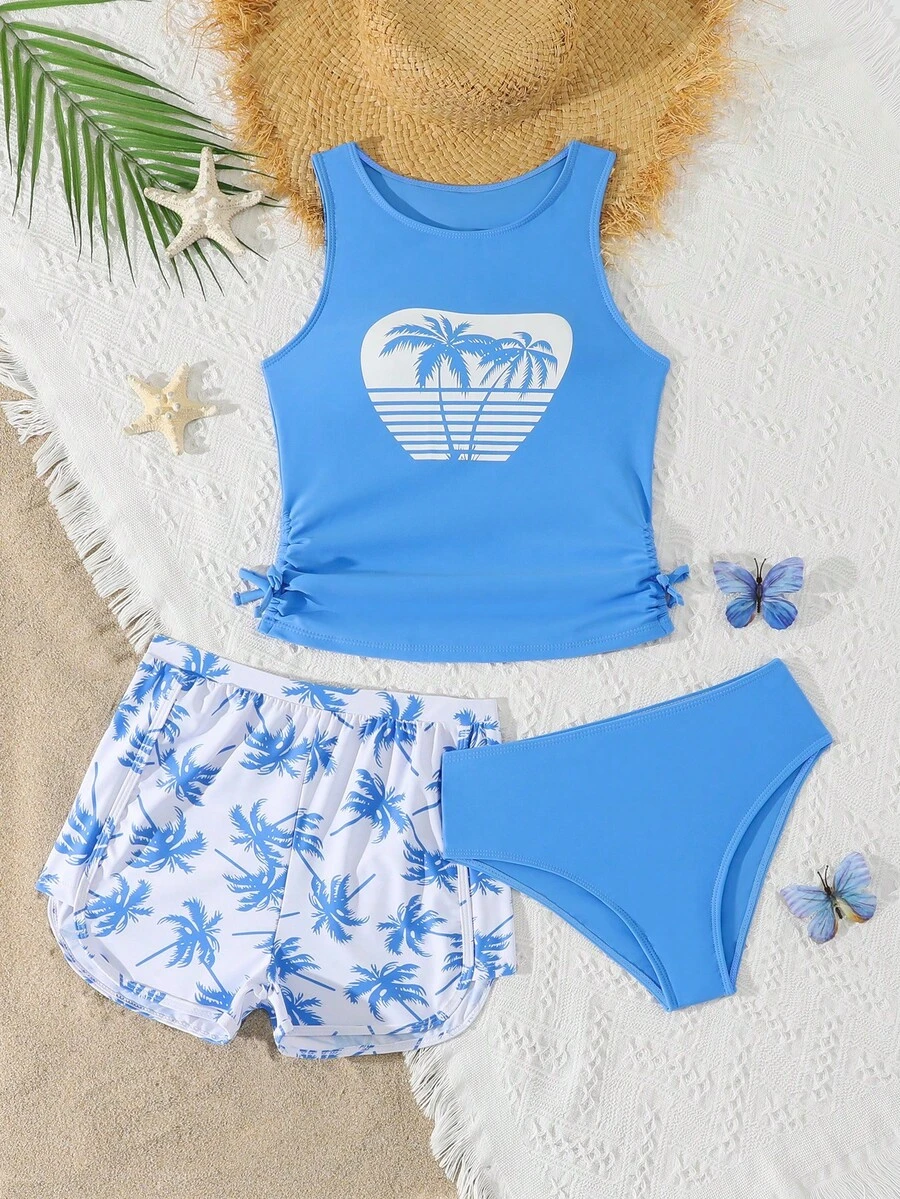 SHEIN Bộ đồ bơi hai mảnh in hình cây cọ và cây dừa màu xanh trắng cho bé gái, kiểu dáng mùa hè mới, nhanh khô và thoải mái. Có dây rút bên hông và quần đùi cạp cao. Thân thiện với da và thoáng khí. Trang phục đi biển/hồ bơi sành điệu cho trẻ em, món đồ không thể thiếu cho vẻ ngoài tươi mới và thoải mái. Trang phục mùa hè cho bé gái, bộ đồ đi biển, trang phục mùa hè, quần áo mùa hè cho thiếu nữ. - Màu xanh lam - Xem 1