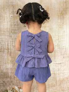 SHEIN Bộ đồ đôi cho bé gái màu tím nhạt dễ thương, có nơ trang trí, kiểu dáng thoải mái, thích hợp cho kỳ nghỉ, gồm áo hai dây và quần short, màu xanh tím nhạt, kiểu dáng hở lưng, thích hợp cho trẻ em. - Màu tím - Xem 11