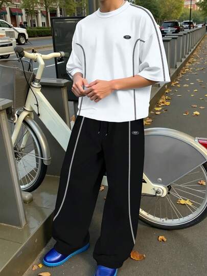 Manfinity Hypemode بدلة رياضية كاجوال للرجال تتكون من تي شيرت بأكمام قصيرة مطبوع عليه حرف وشورت