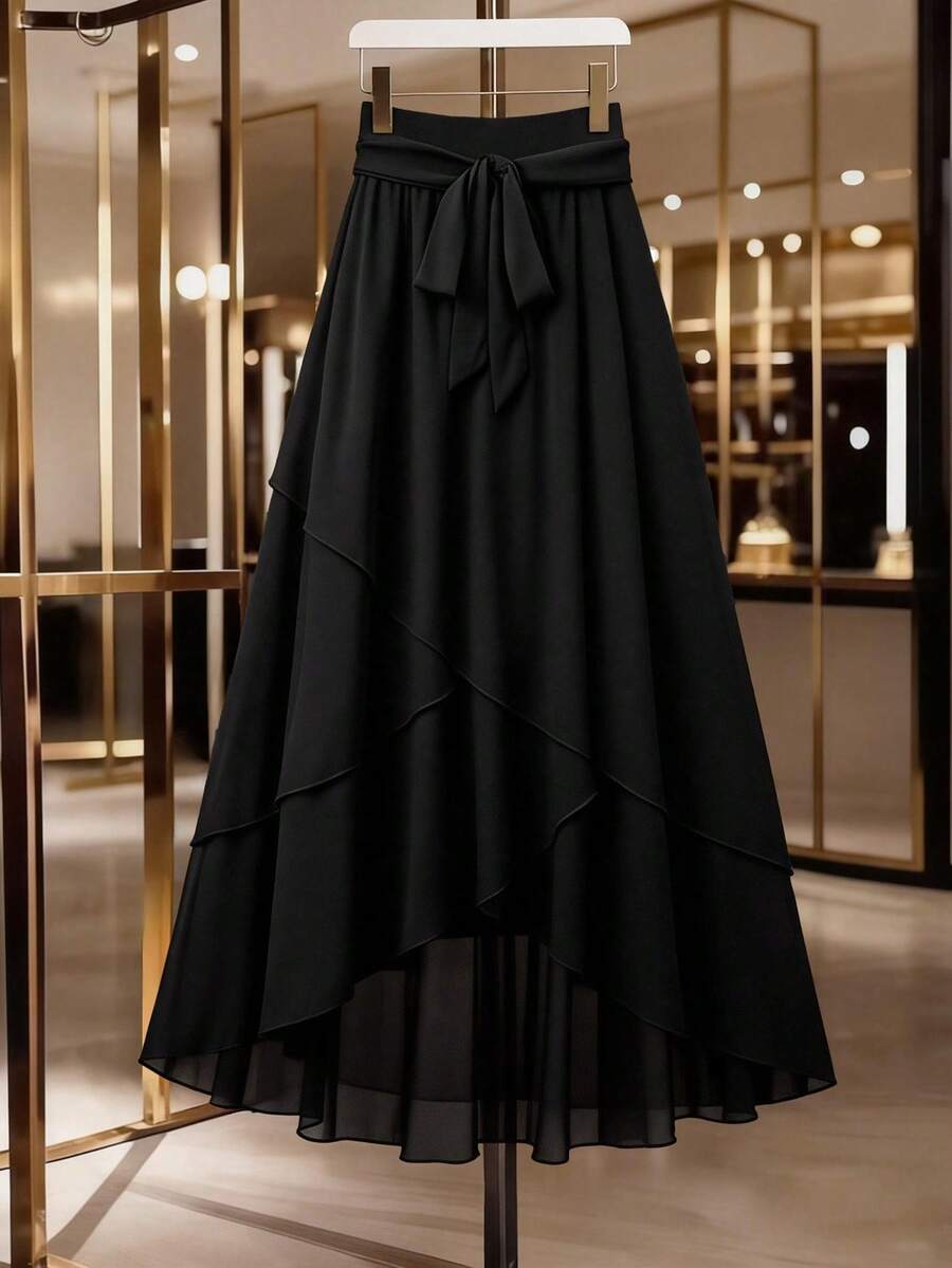 GlowEve CURVE Chân váy midi dáng rộng thanh lịch bằng chiffon với nơ thắt eo - Chân váy dài màu đen mùa hè dành cho nữ, chân váy đen vạt trước ngắn vạt sau dài, chân váy nơ đen, chân váy xếp tầng, chân váy thanh lịch. - màu đen - Xem 1