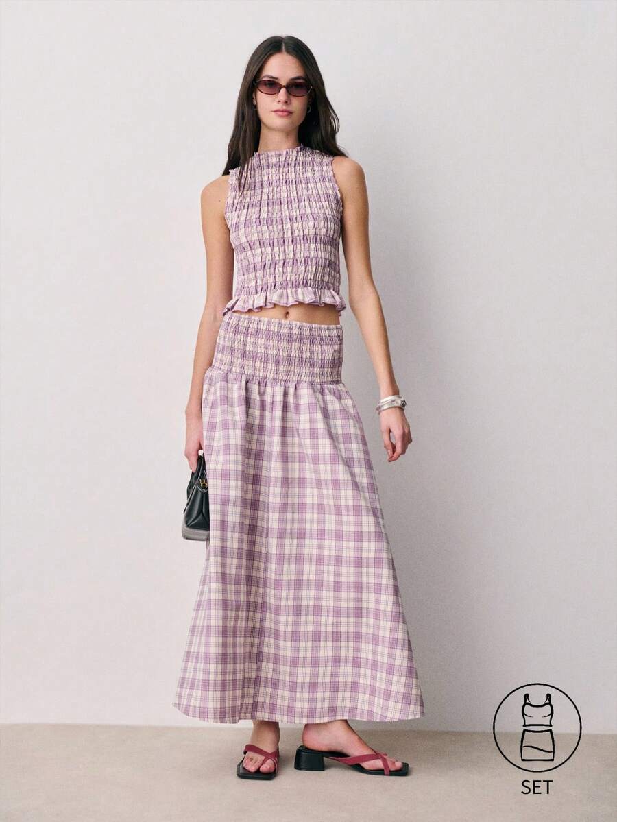 Nöista Bộ đồ hai mảnh không tay kẻ caro với phần thân trên xếp ly và chi tiết bèo nhún ở eo và cổ áo, kết hợp với chân váy xếp ly cùng màu. Nhẹ nhàng và nữ tính, bộ trang phục mùa xuân hè phối hợp này dành cho nữ giới hoàn hảo cho vẻ ngoài thanh lịch thường ngày, trang phục hàng ngày và phong cách thời tiết ấm áp. - Màu tím - Xem 1