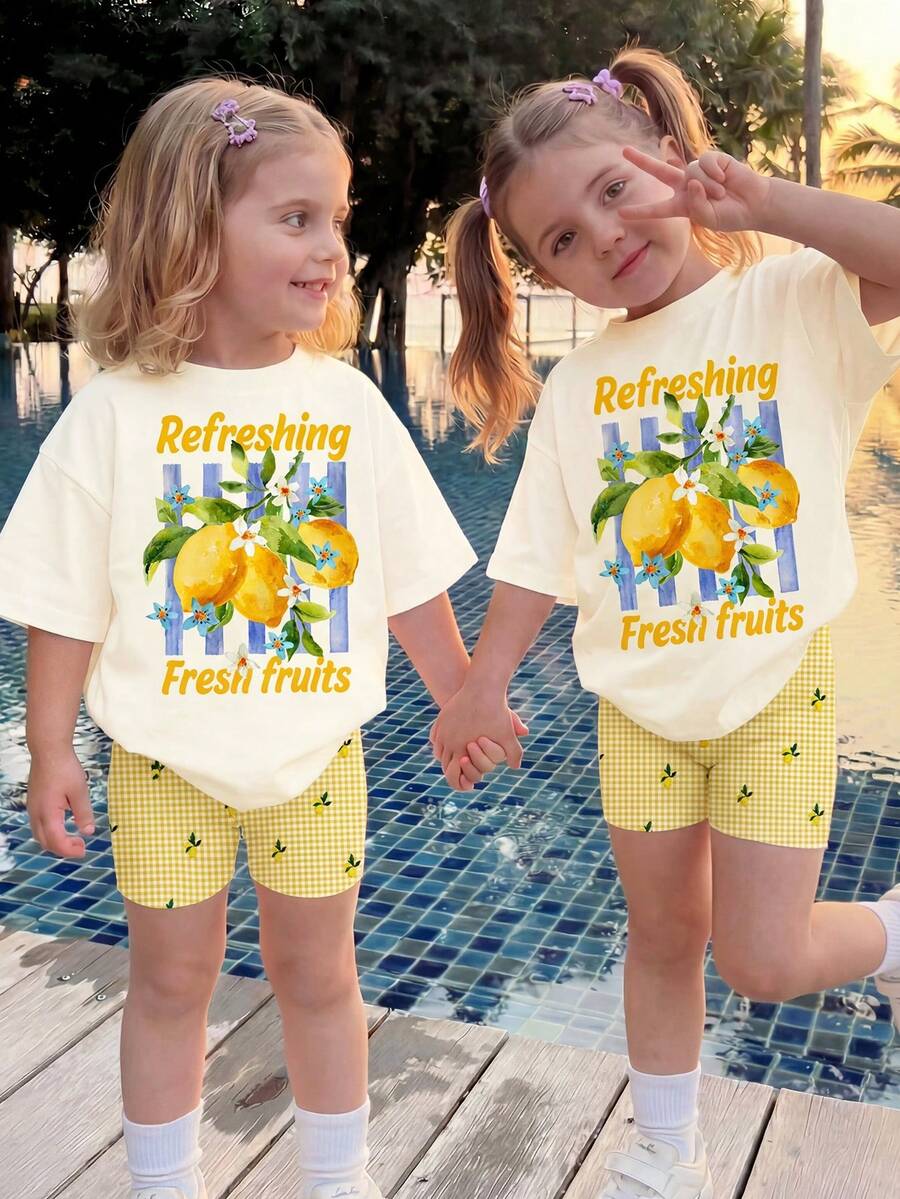 SHEIN Sweet Retro Cream Lemon Tree Print Pattern, Fresh Yellow Plaid Print Pattern, Resort Countryside Style, Baby Girl Casual Loose Round Neck Short Sleeve T-Shirt And Skinny Bike Shorts Set, Suitable For Spring/Summer, Cute Summer Outfits For Summer Kids Items, Summer Outing Items, Korean Style, Easy Comfort, Stylish Kids, Y2K, Kawaii, Party, Everyday, Vacation, Cute, Comfy, Summer 2026, Cottagecore, Weekend Casual, Family Outing, Photoshoot Outfits, Chill Chill, Baby & Kids Graphic Tops - Multicolor - View 1