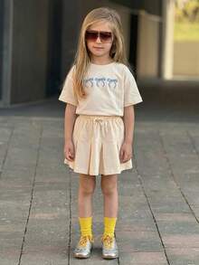 DAZY Young Girl Bow Print Round Neck Short Sleeve T-Shirt And Drawstring Waist Pleated Mini Skirt Casual Set Spring - Beige - View 3