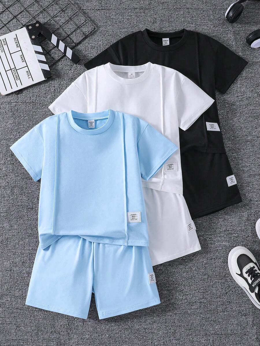 SHEIN 6件套儿童夏季休闲简约时尚圆领T恤短裤套装,包含蓝色、黑色和白色三套儿童短袖短裤套装。款式简约,短袖搭配短裤,日常穿着舒适,适合儿童,活动自如,设计简洁,易于搭配其他配饰或外套,可作为满足日常休闲需求的儿童基本款服装。 - 彩色 - 查看 1