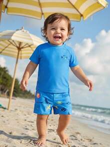 SHEIN Bộ đồ bơi ngắn tay cổ tròn ôm sát in hình cá mập hoạt hình dễ thương cho bé trai, thích hợp cho mùa hè. - Nhiều màu - Xem 9