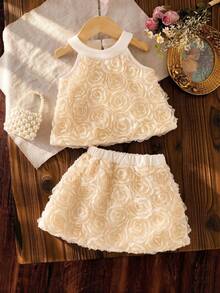 女婴纯色3D立体花朵吊带上衣和A字裙两件套。3D立体花朵面料增添无限魅力。设计美观舒适，无袖上衣搭配A字裙，尽显小女孩的甜美活泼。无论是户外度假还是与家人朋友聚会，宝宝都能成为众人瞩目的焦点。适合各种场合。 - 杏色 - 查看 4