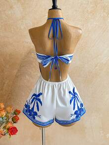 Soleia Bộ jumpsuit ngắn hở lưng in họa tiết hoa nhiệt đới kiểu dáng mùa hè mới này, với điểm nhấn kim loại lấp lánh, hoàn hảo cho các bữa tiệc, hẹn hò, ngày Valentine, lễ Phục sinh, lễ hội, tiệc trà chiều, bãi biển, du thuyền, kỳ nghỉ thành phố, phong cách bohemian, họa tiết hoa lãng mạn và các dịp khác. - Nhiều màu - Xem 7