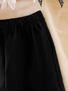 Bộ 2 món cho bé gái gồm áo thun cổ chữ V dệt kim họa tiết hoa và quần ống đứng, thiết kế thời trang độc đáo, thích hợp cho mùa hè. - màu đen - Xem 3